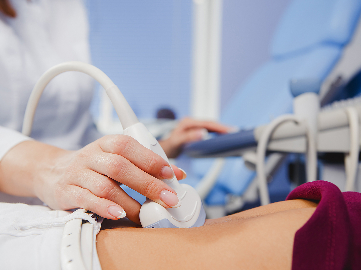 Ärztin beim Bauchultraschall einer jungen Frau